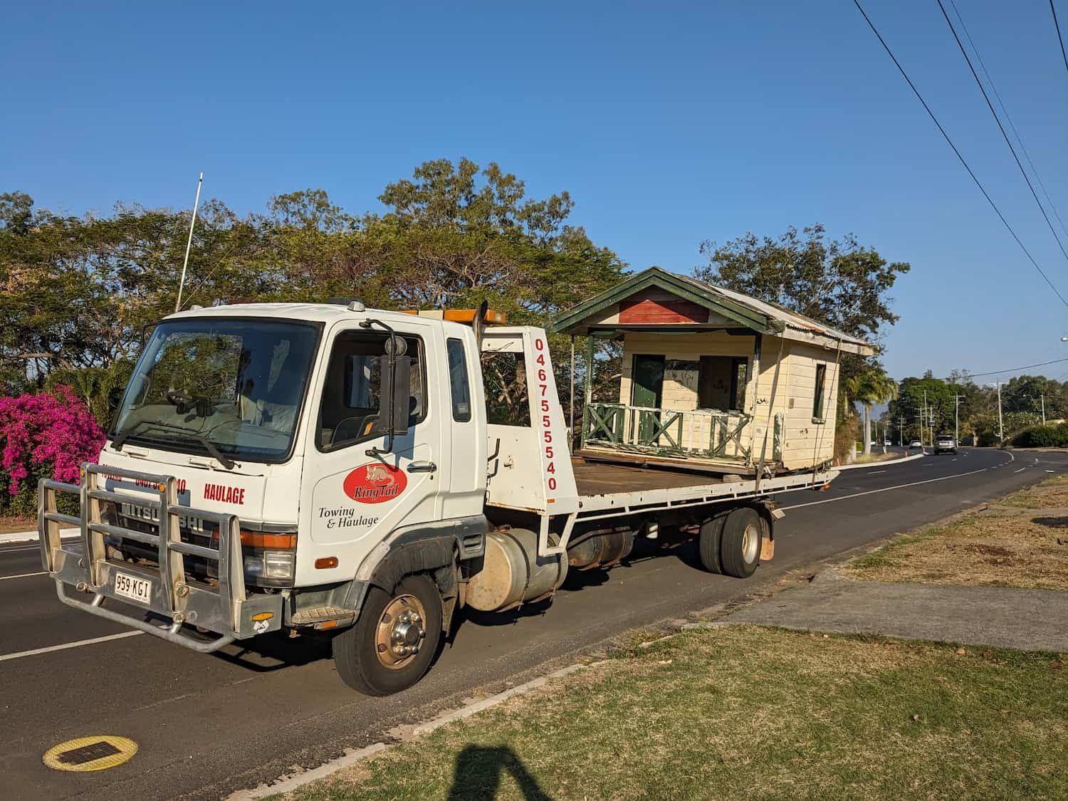 A Small House Being Transported on a Flatbed Truck on a Road — Ringtail Towing in Mareeba, QLD