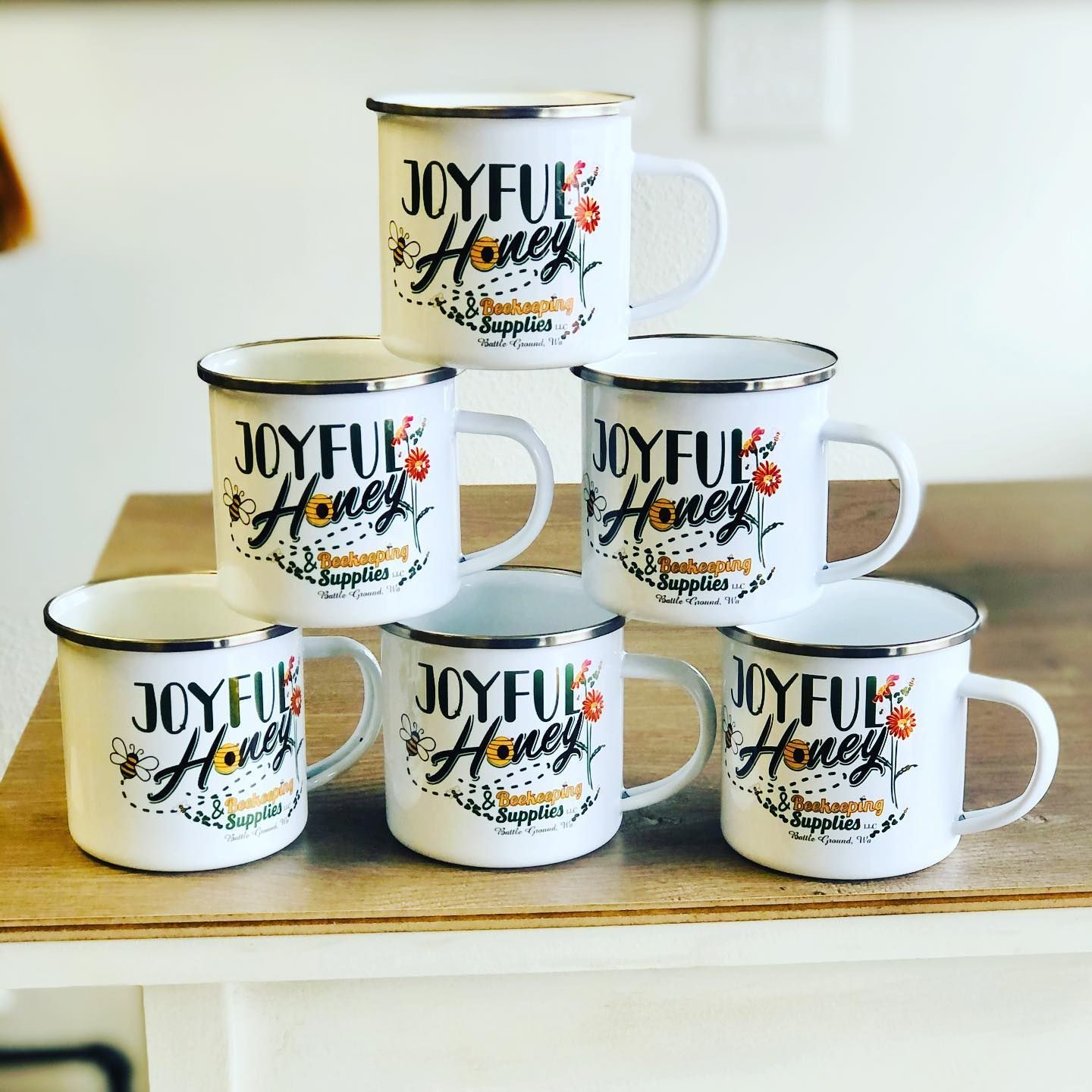 Two shirts and a mug with the h & b electric logo on them