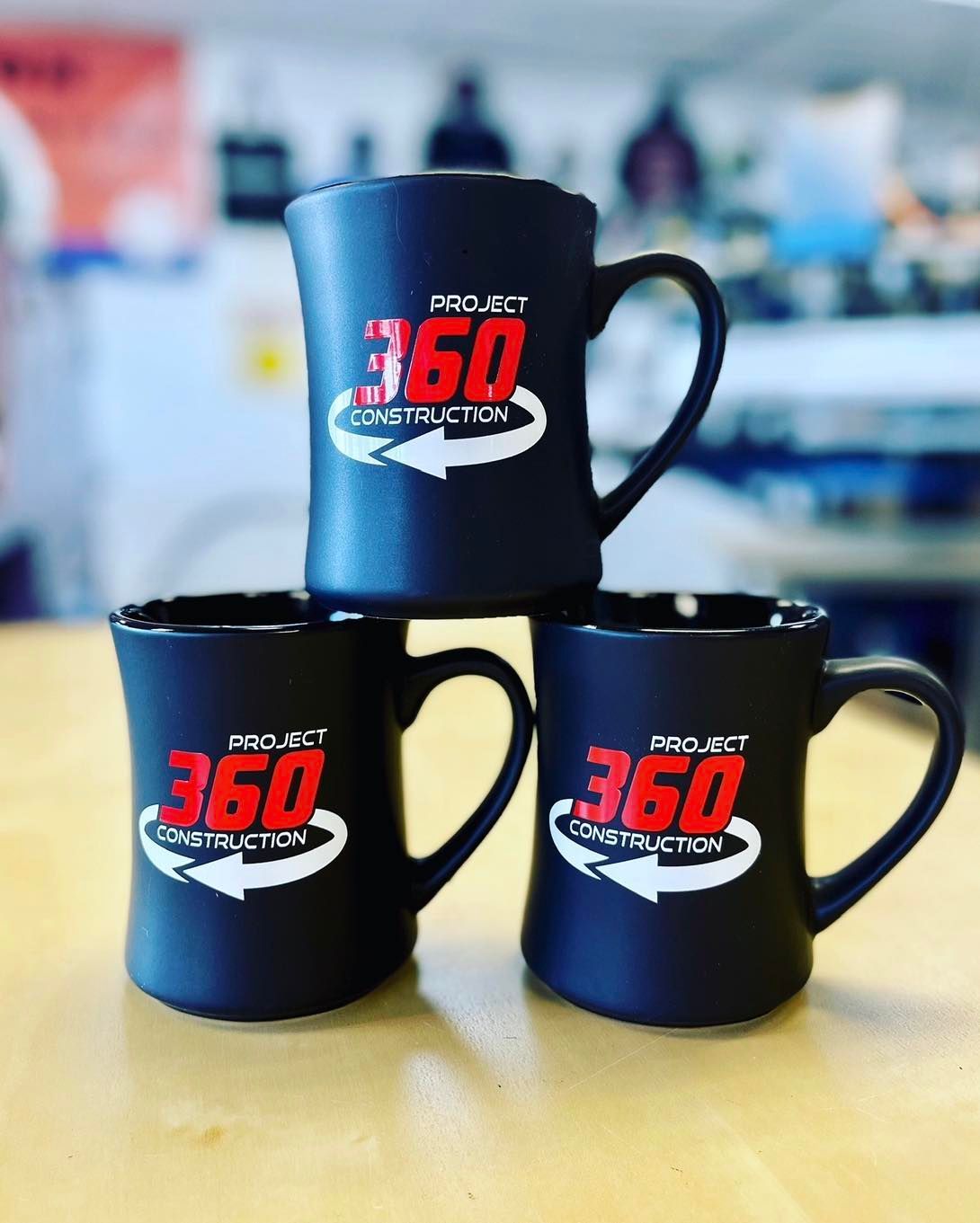 Two shirts and a mug with the h & b electric logo on them