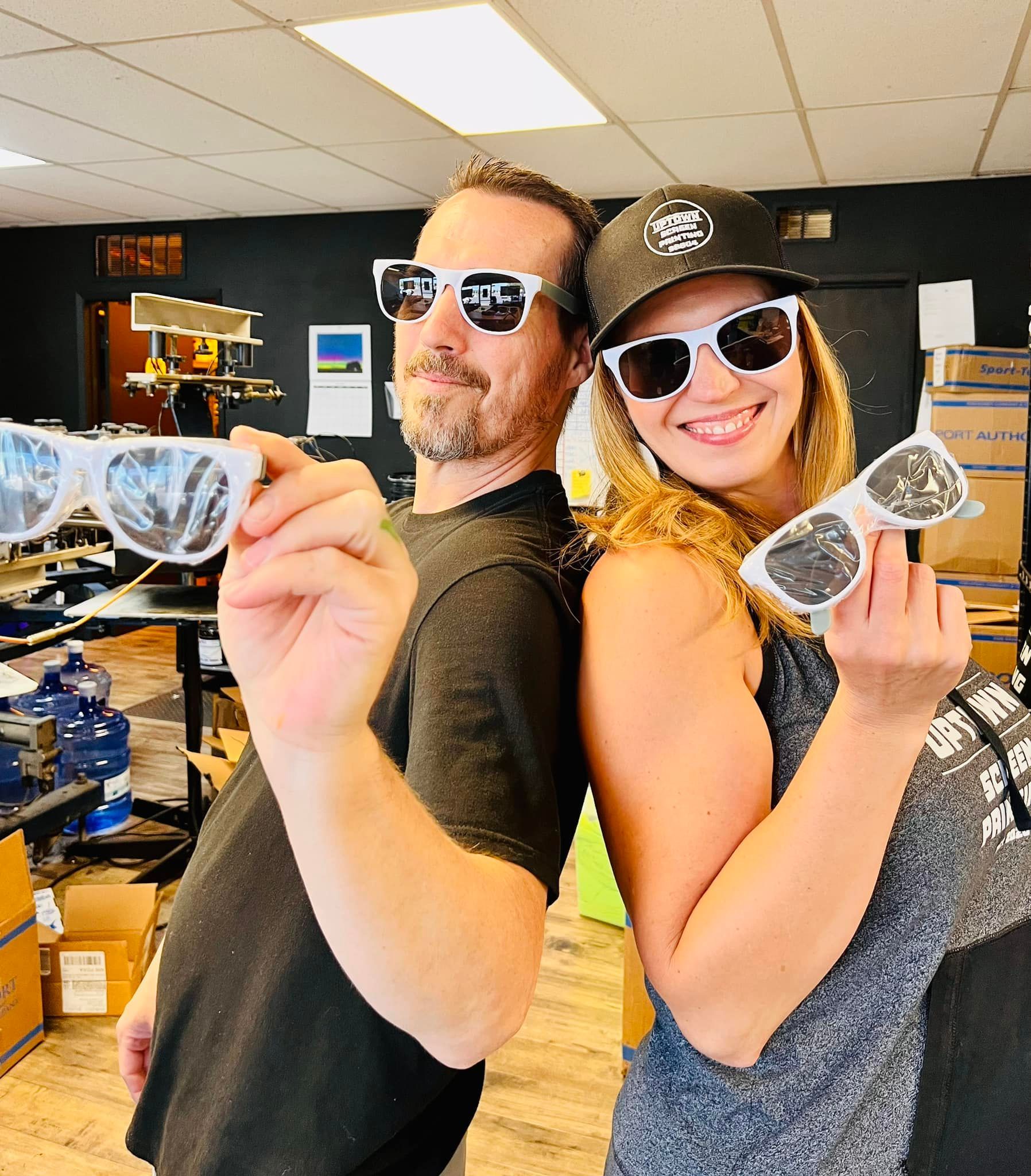 A blue bag that says uptown screen printing on it