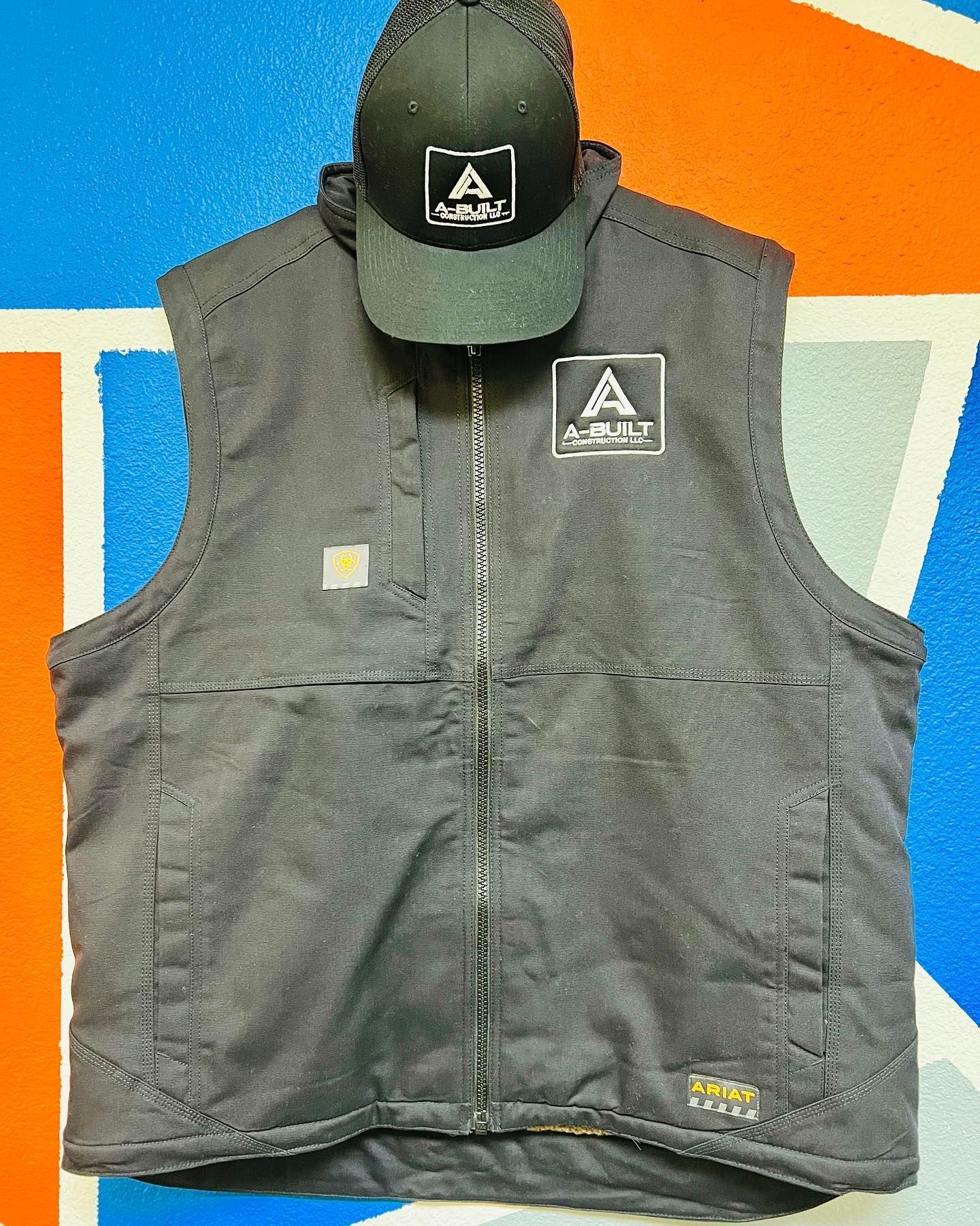 A black vest with a hat on top of it
