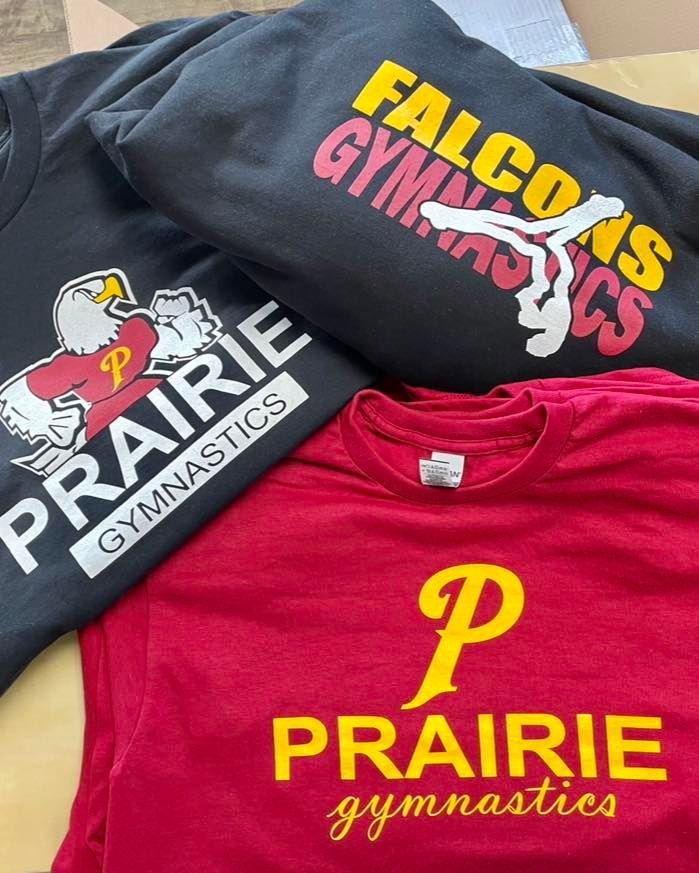 Three prairie gymnastics shirts are stacked on top of each other