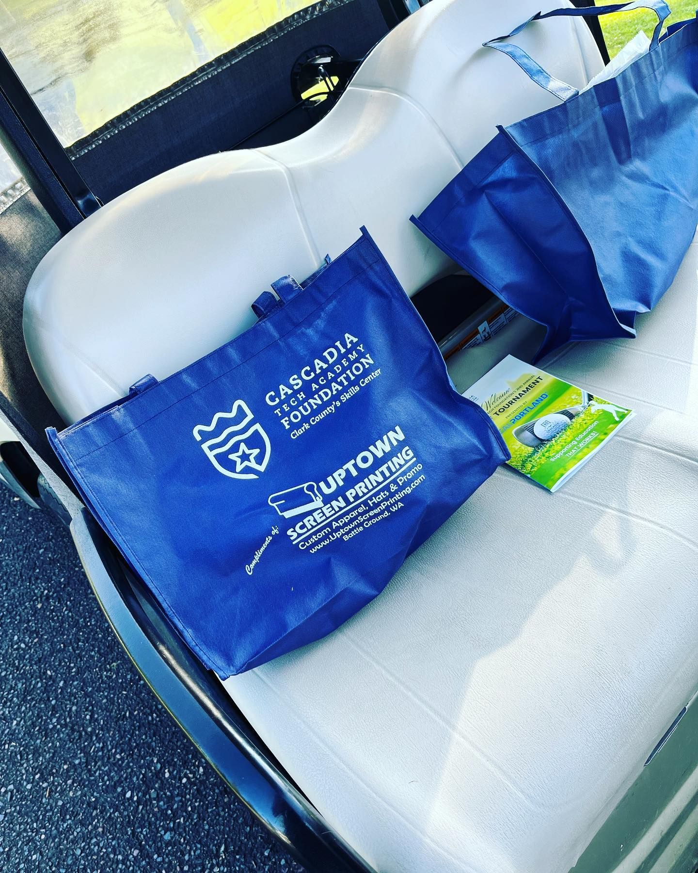 A blue bag that says uptown screen printing on it