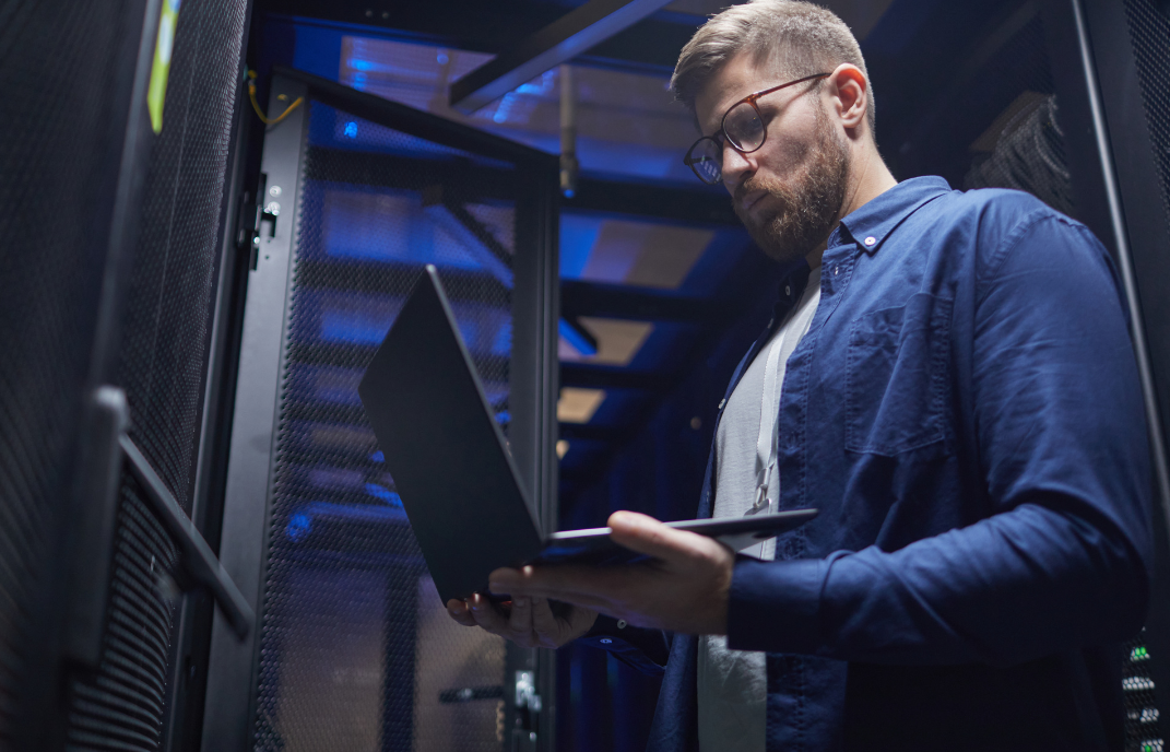 Server rack with colorful fiber optic cables connected to ports.