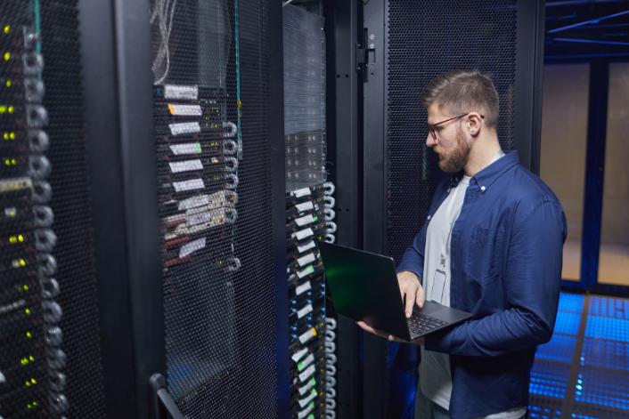 Server rack with colorful fiber optic cables connected to ports.
