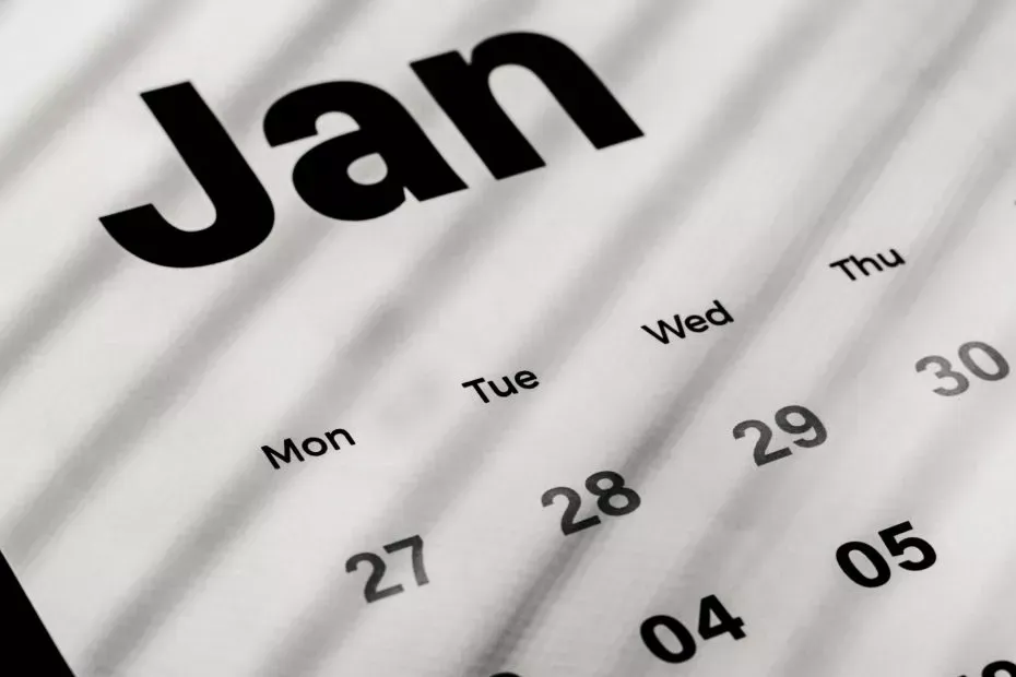 Close-up of a January calendar, with days numbered and bolded, grayscale image.