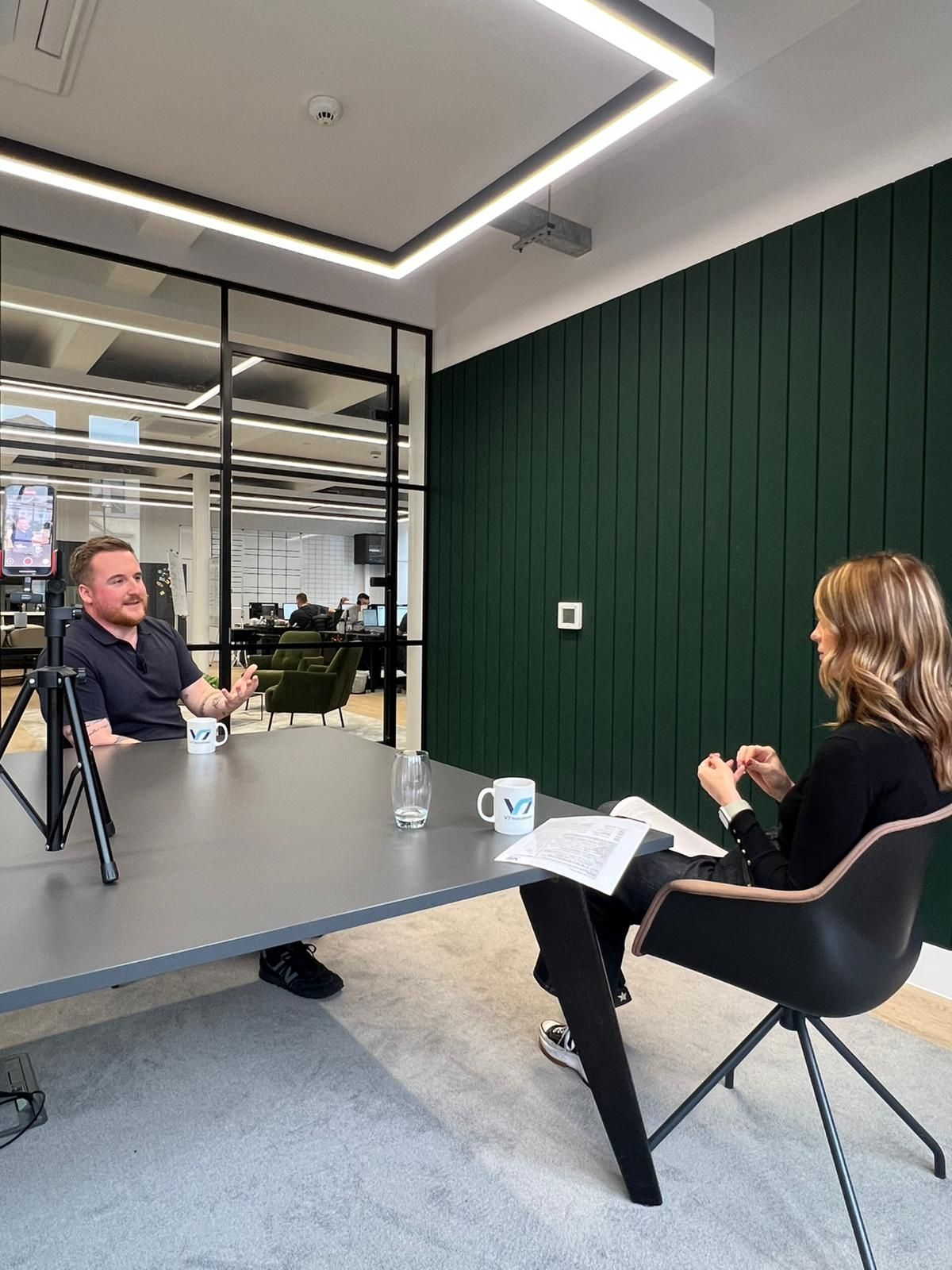 Circular graphic for Recruiter Awards 2025: shortlisted. Blue, pink, gold with a white figure. V7 Recruitment logo.