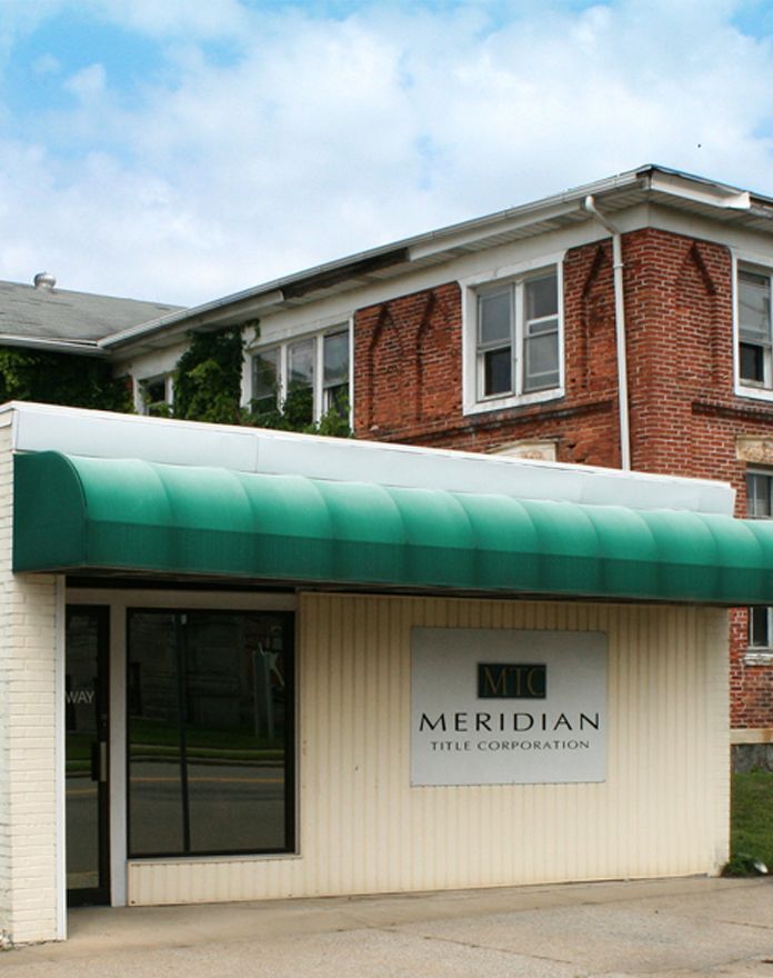 A meridian title corporation building with a green awning