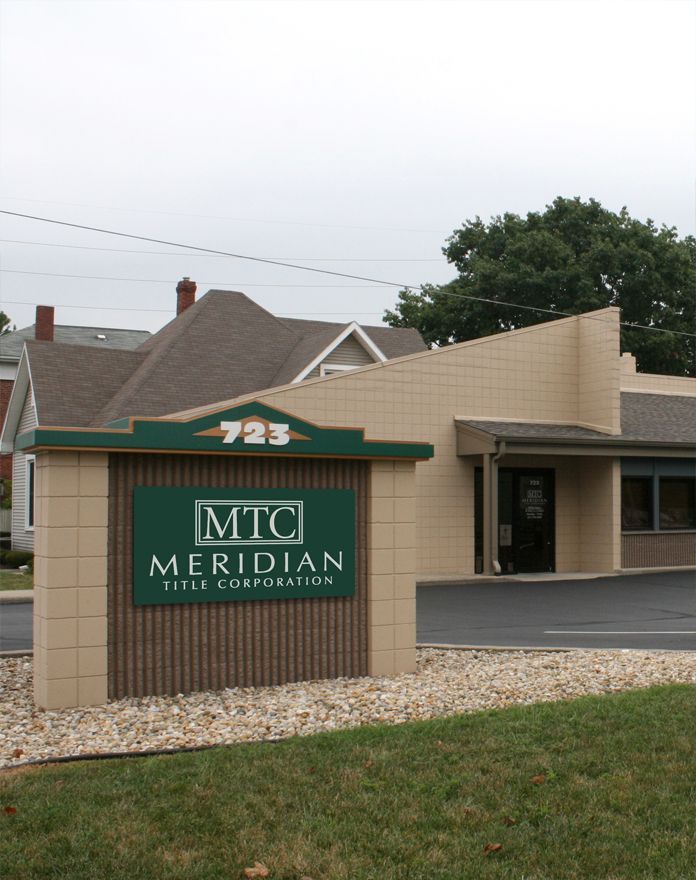 A sign for mtc meridian sits in front of a building