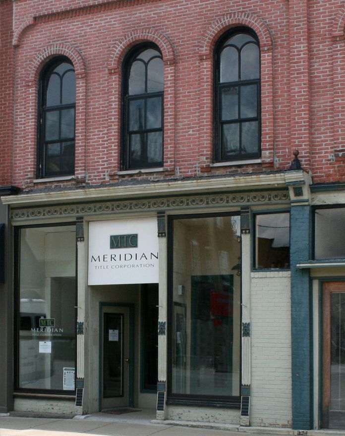 A brick building with a sign that says meridian on it