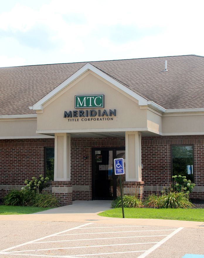 A brick building with a sign that says mtc meridian hotel corporation