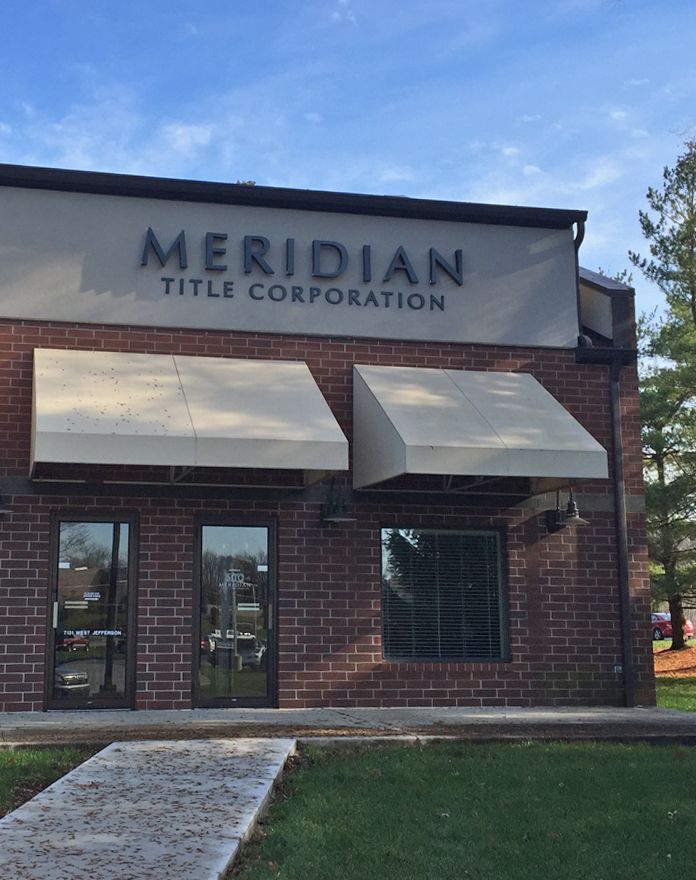 A brick building with a sign that says meridian title corporation