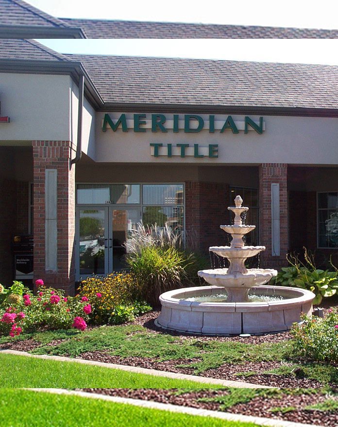 A fountain in front of a building that says meridian title