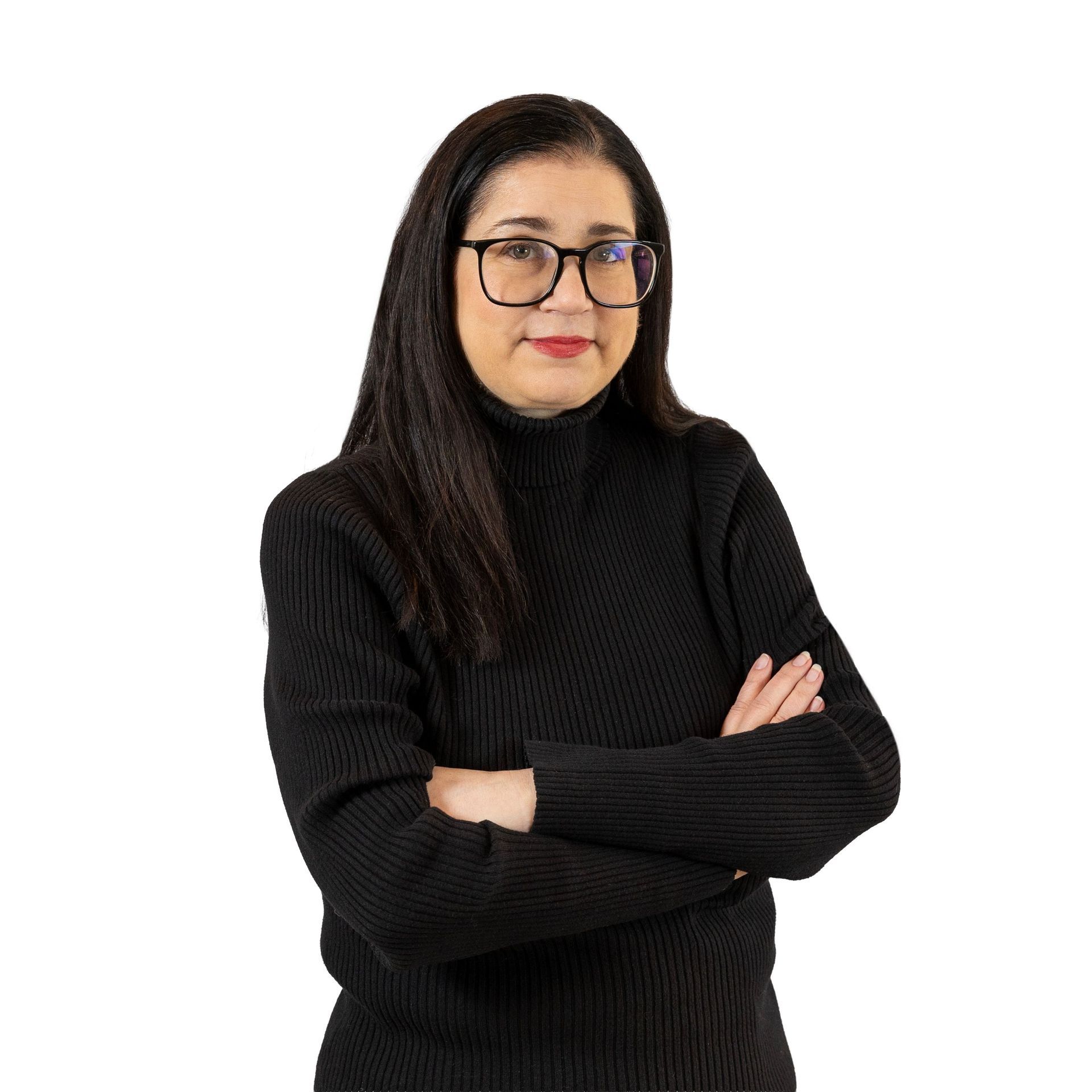 A smiling person with shoulder-length brown hair and glasses, wearing a dark blazer over a bright pink top.