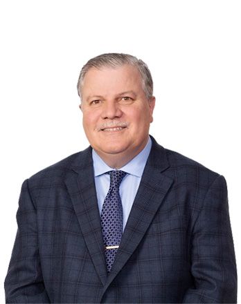 A man in a suit and tie is smiling for the camera.