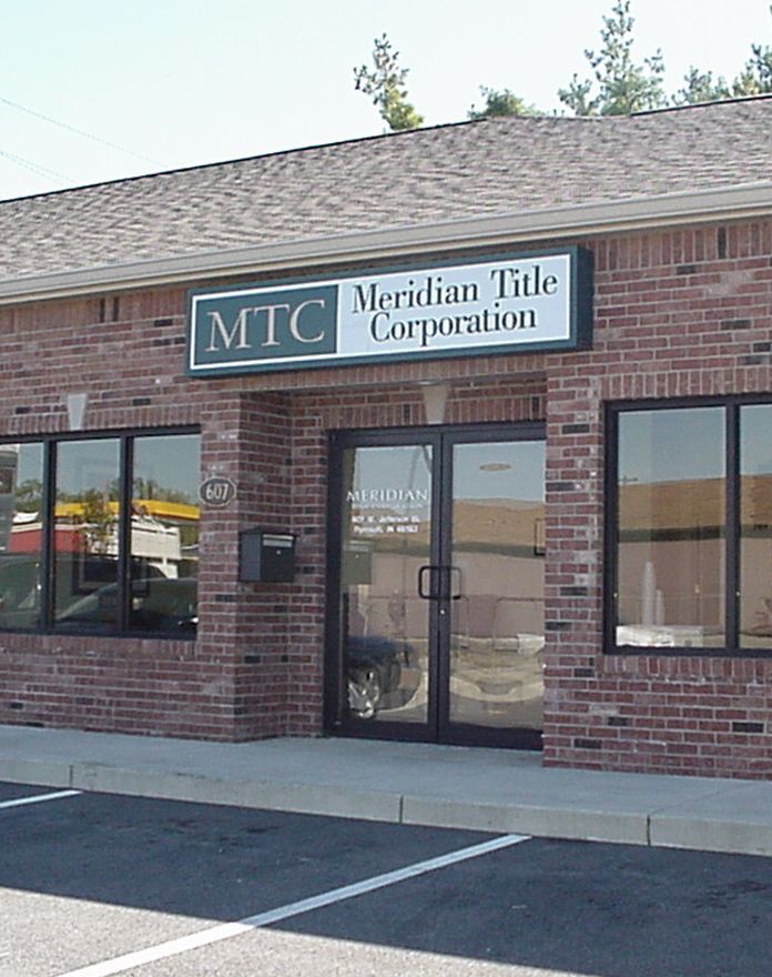 A brick building with a sign that says mtc on it