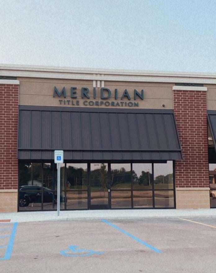 A meridian title corporation building with a parking lot in front of it