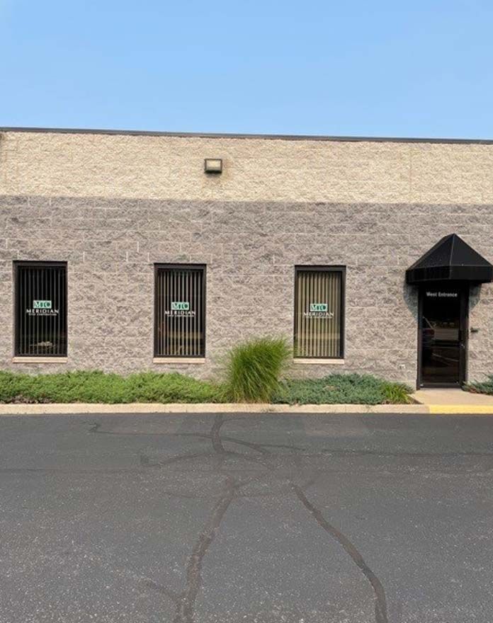 A large brick building with a lot of windows and a door.