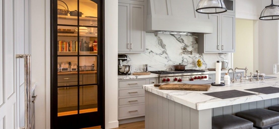 A kitchen with a sliding glass door leading to a pantry.
