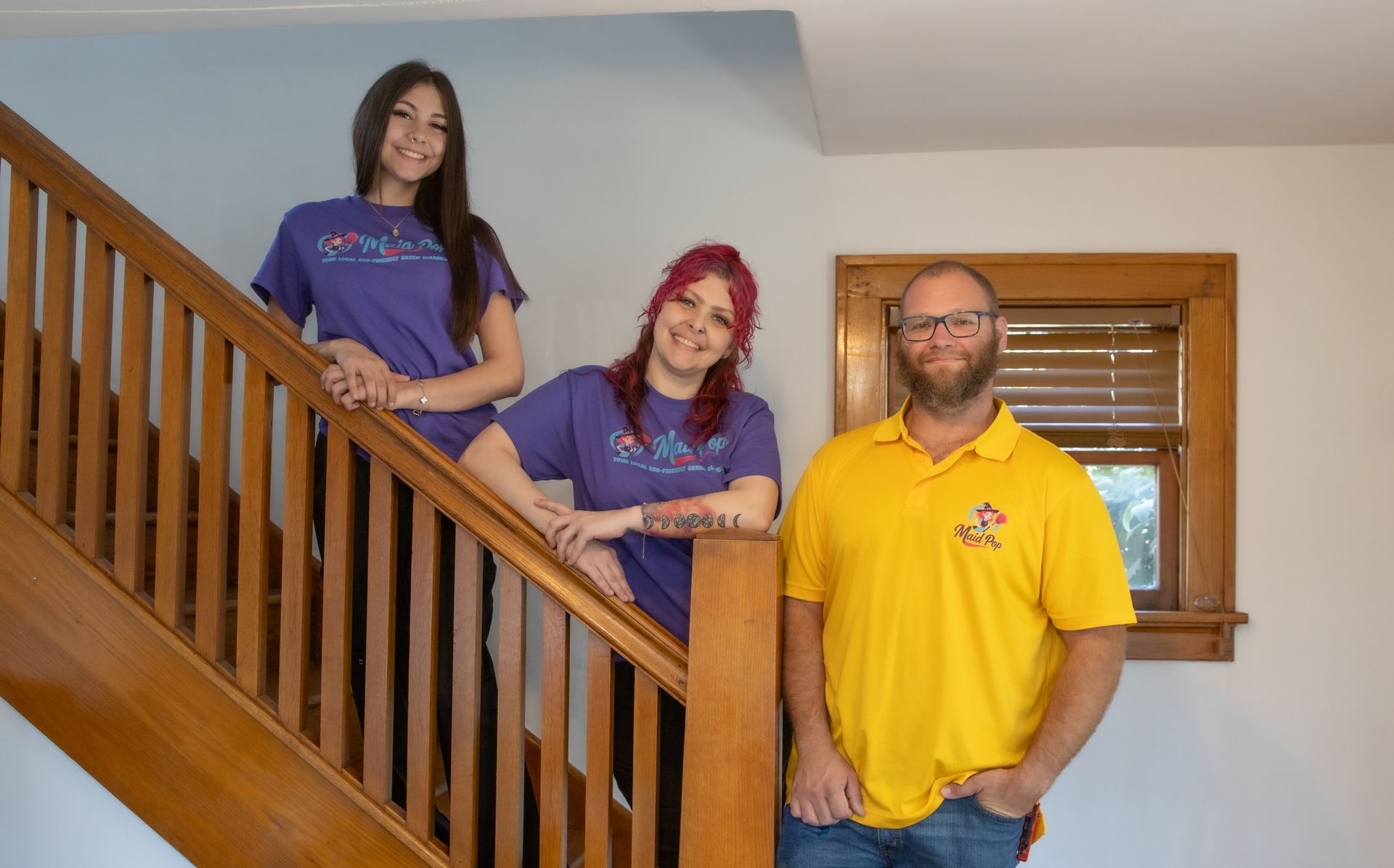 Three people on wooden stairs