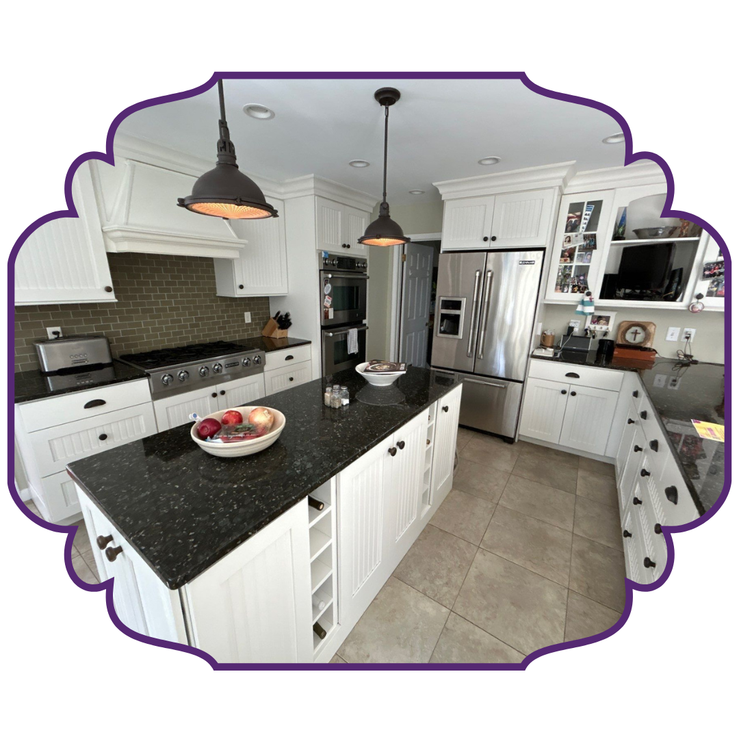 Kitchen with white cabinets, dark countertops, island with wine rack, and stainless steel appliances