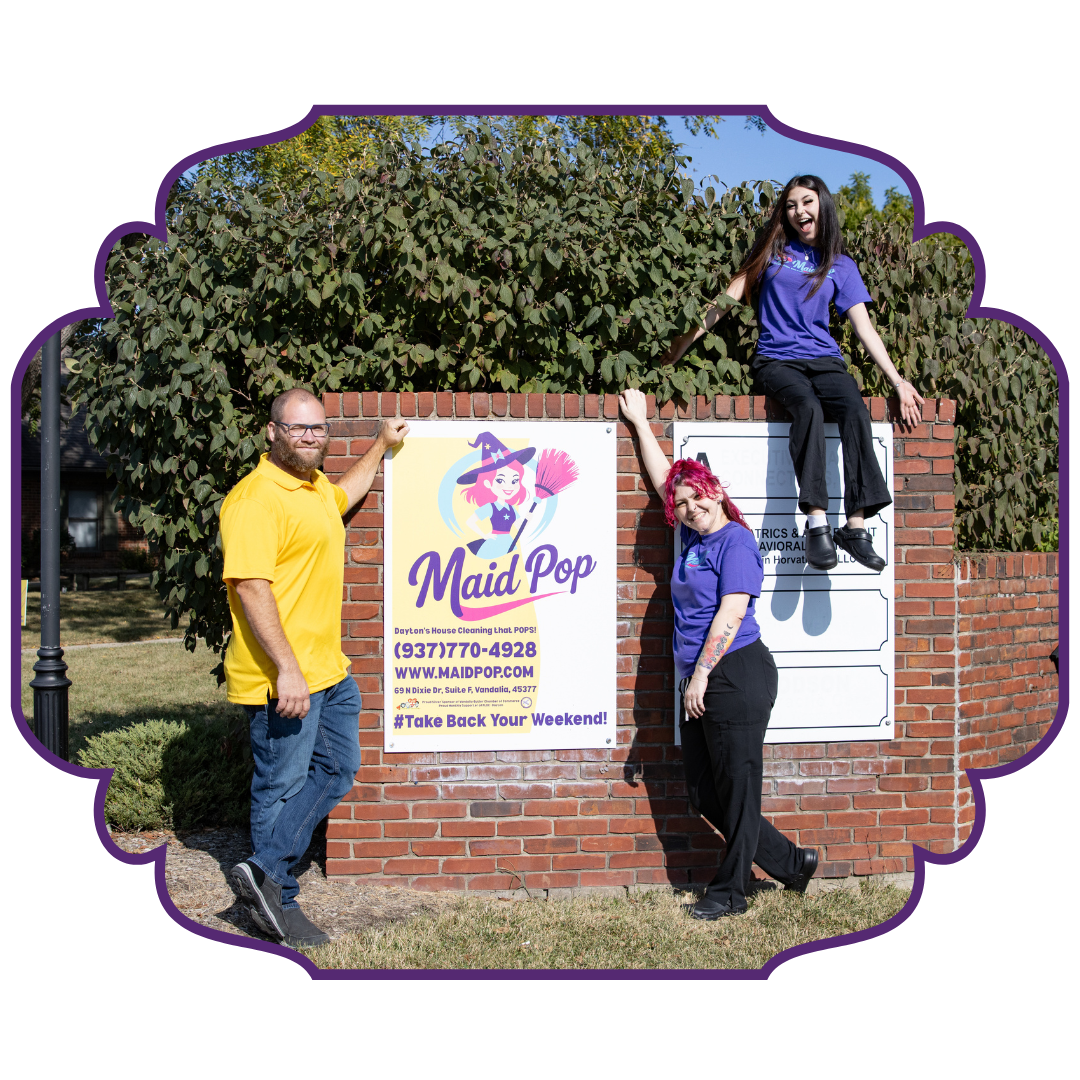 Three people pose with a Three people pose with a