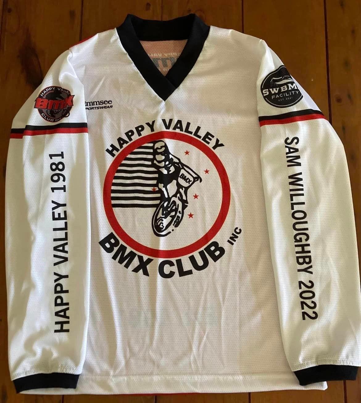 A happy valley bmx club jersey is on a wooden table