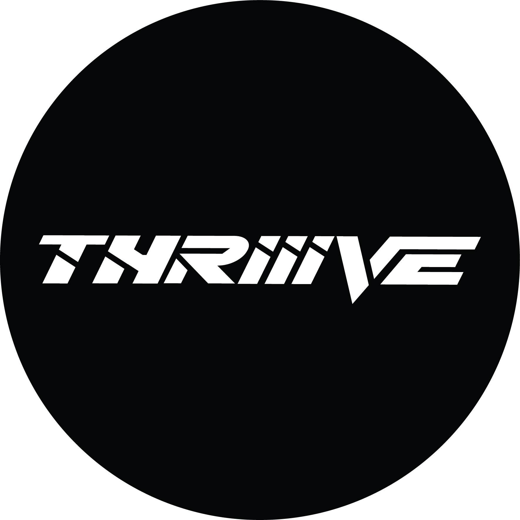 A black tire cover with the word thrive on it.