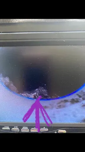 Broken car display screen with purple arrow pointing towards the damage.