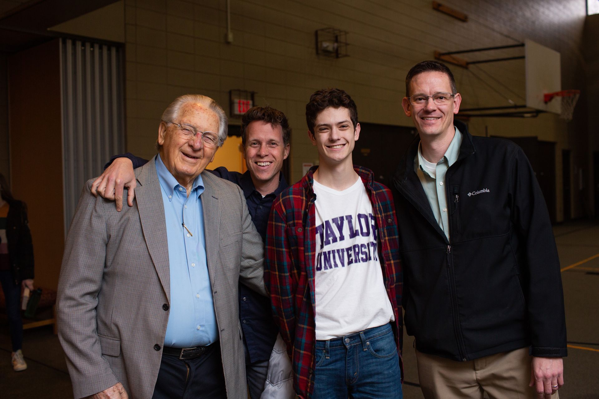 two men are sitting next to each other on a blue couch .
