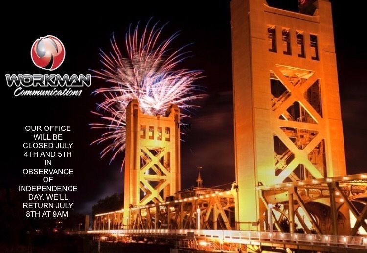 An advertisement for workman communications shows fireworks over a bridge