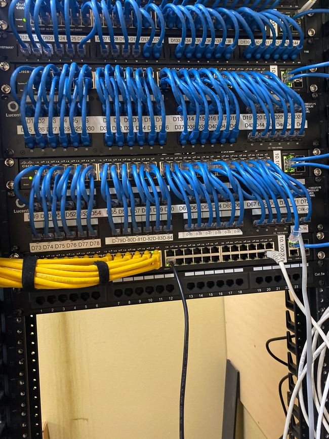 A server rack filled with blue and yellow wires