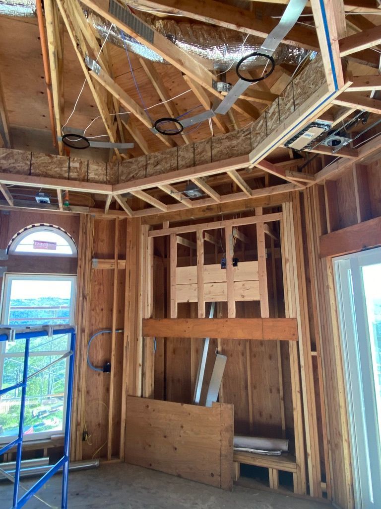 A room in a house under construction with a bunk bed.