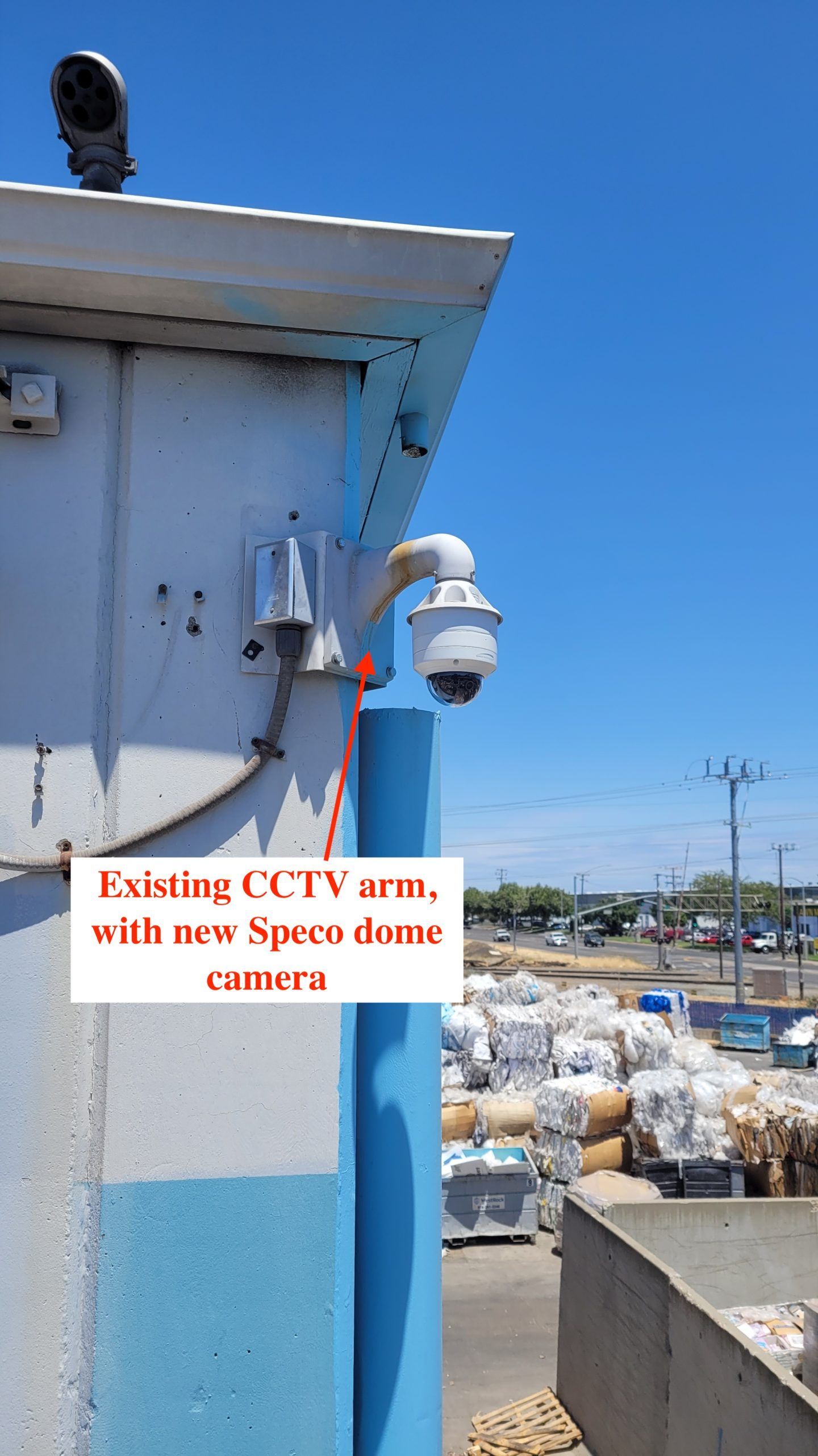 A cctv camera is mounted on the side of a building.