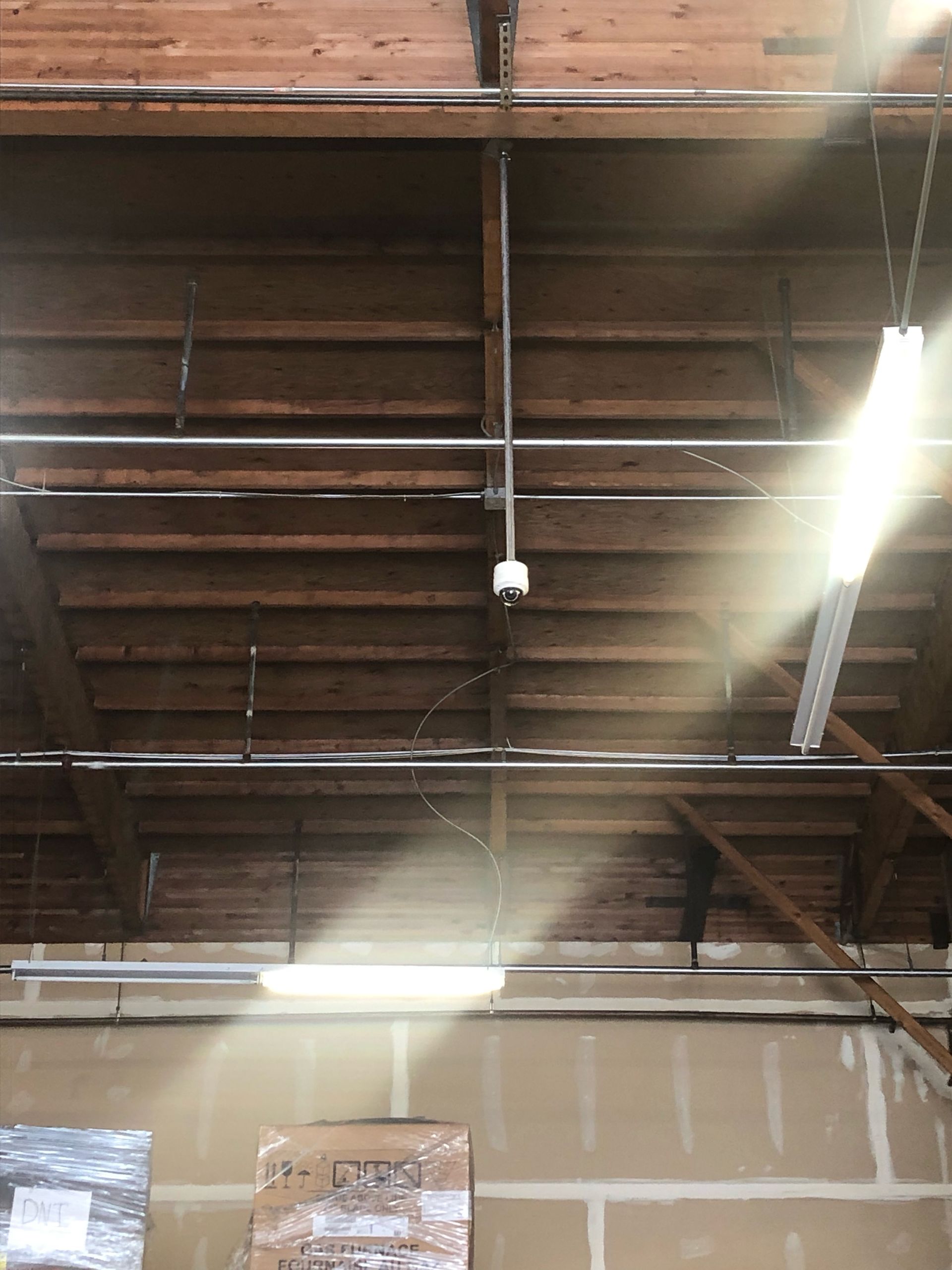 The light is shining through the ceiling of a building