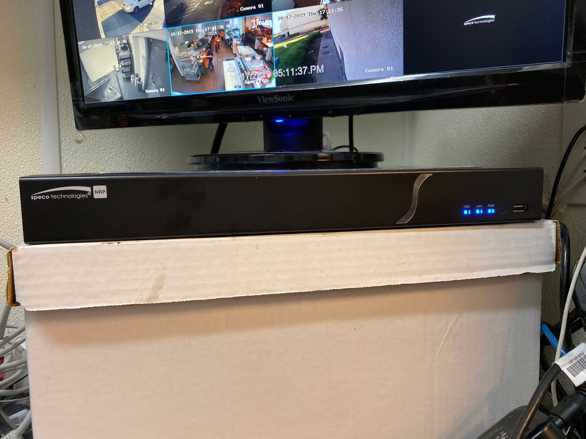 A computer monitor is sitting on top of a cardboard box.