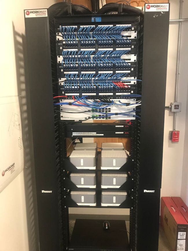 A server rack filled with lots of wires and boxes.