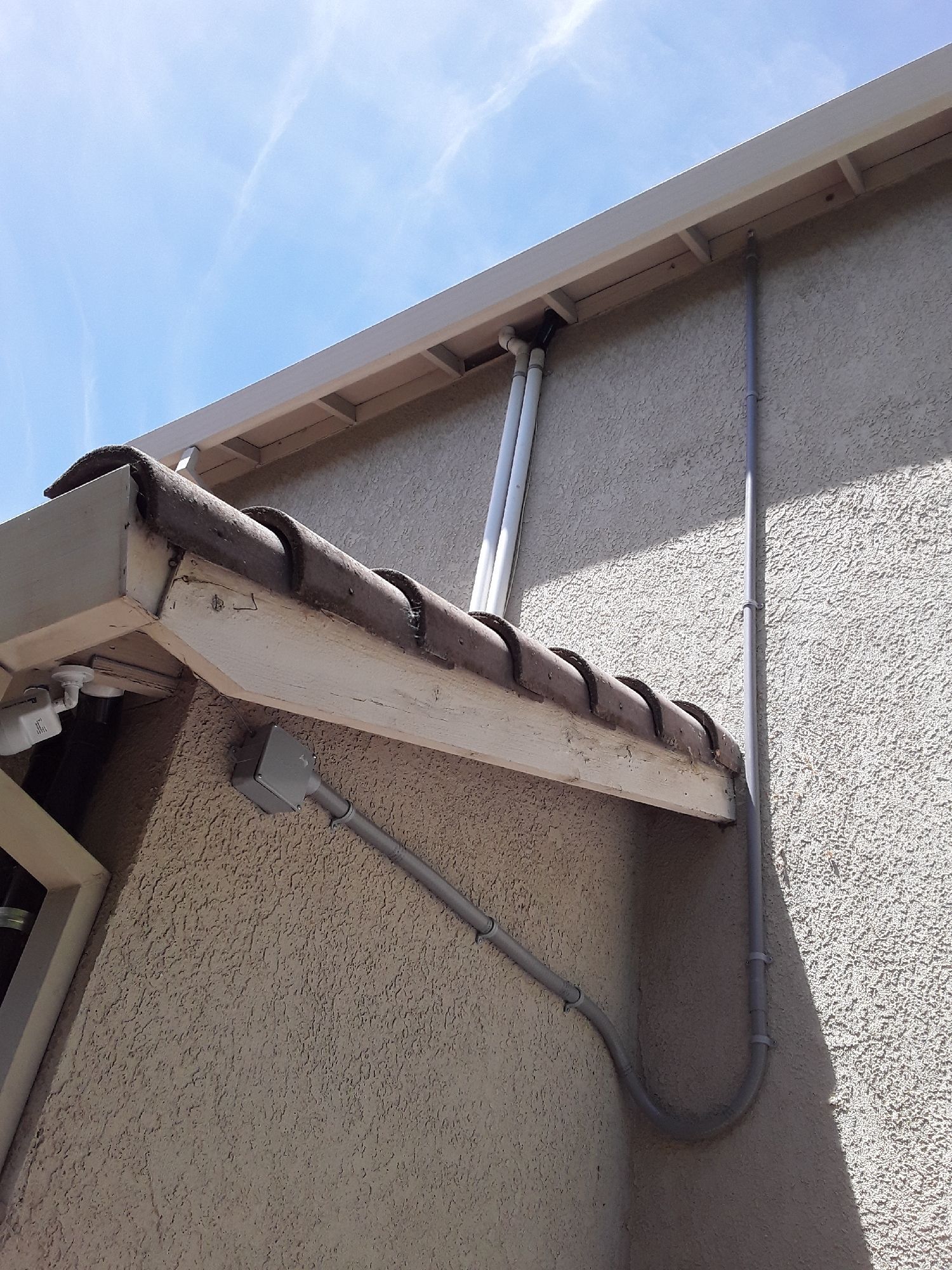 A roof with a gutter and a pipe attached to it