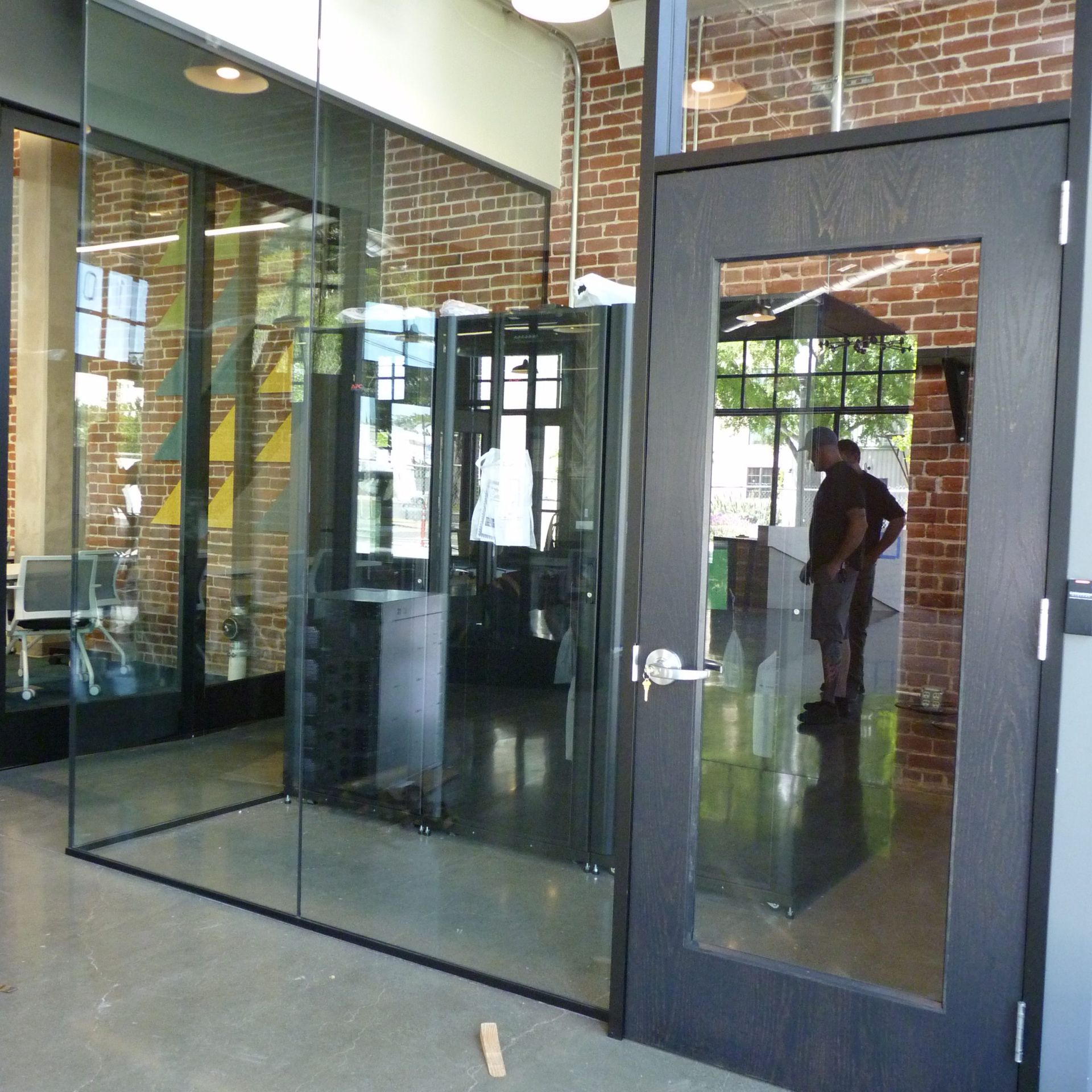 A man is standing in front of a glass door