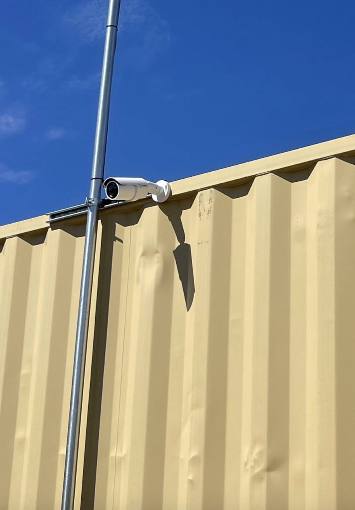 A security camera is mounted on the side of a building.