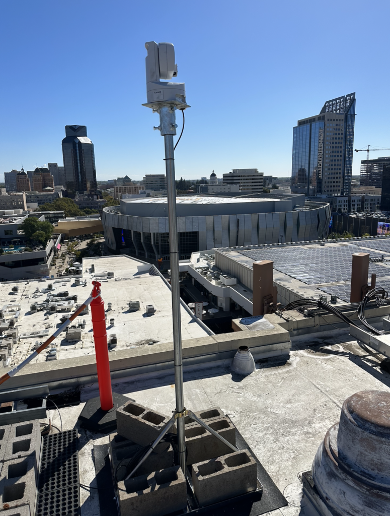 A tower on top of a building with a city in the background