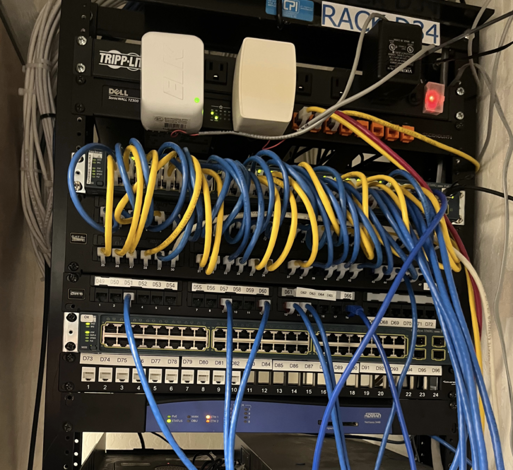 A server rack with a lot of wires connected to it.