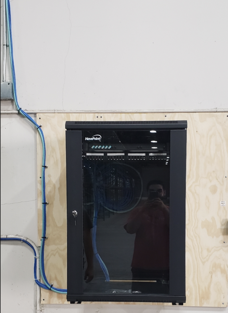 A black cabinet with a reflection of a person in it