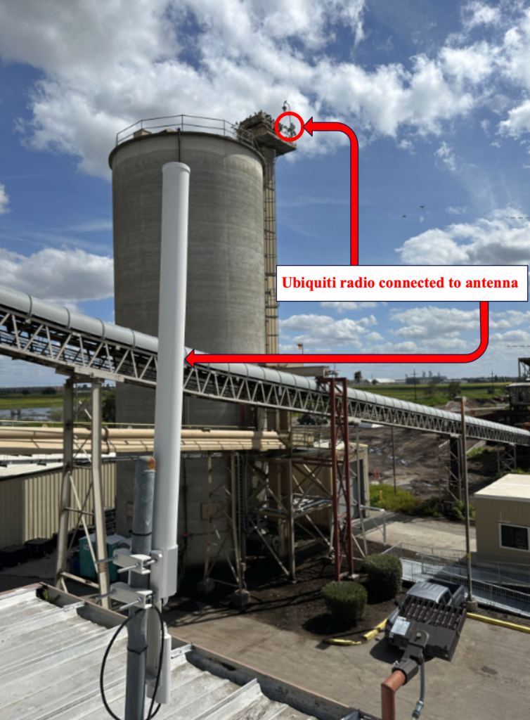 A silo in a factory with a red arrow pointing to it.