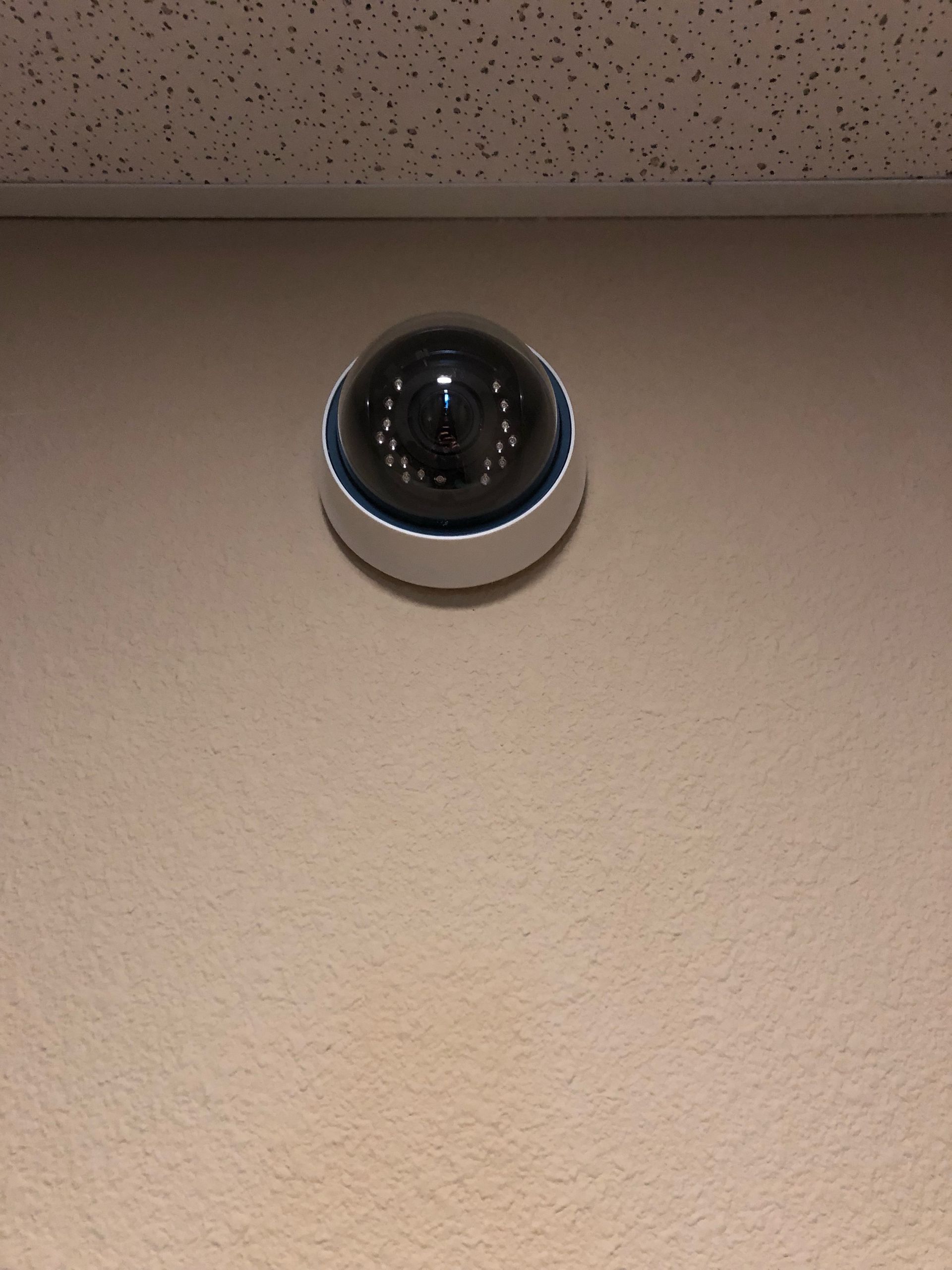 A security camera is mounted on a wall