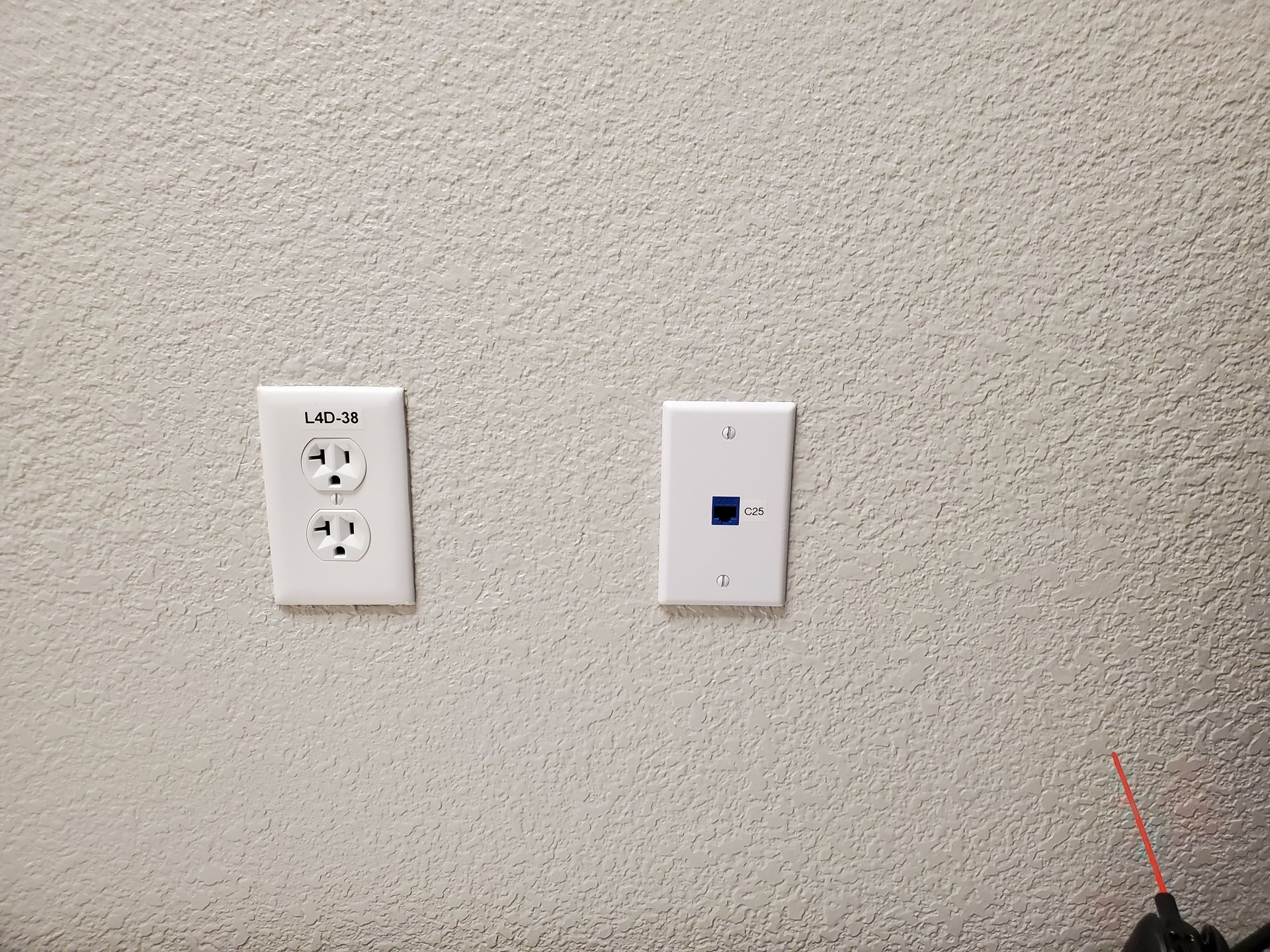 Two white electrical outlets are on a white wall.