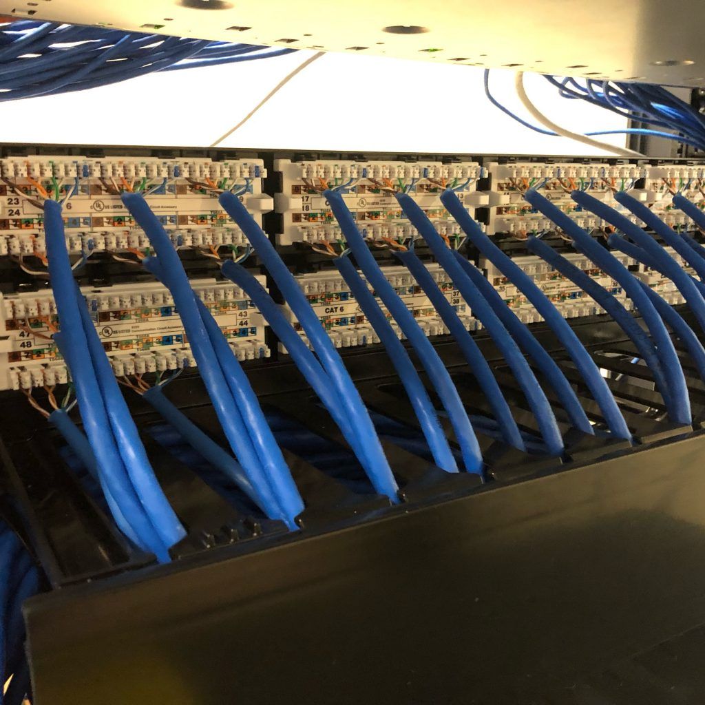 A bunch of blue wires are connected to a server