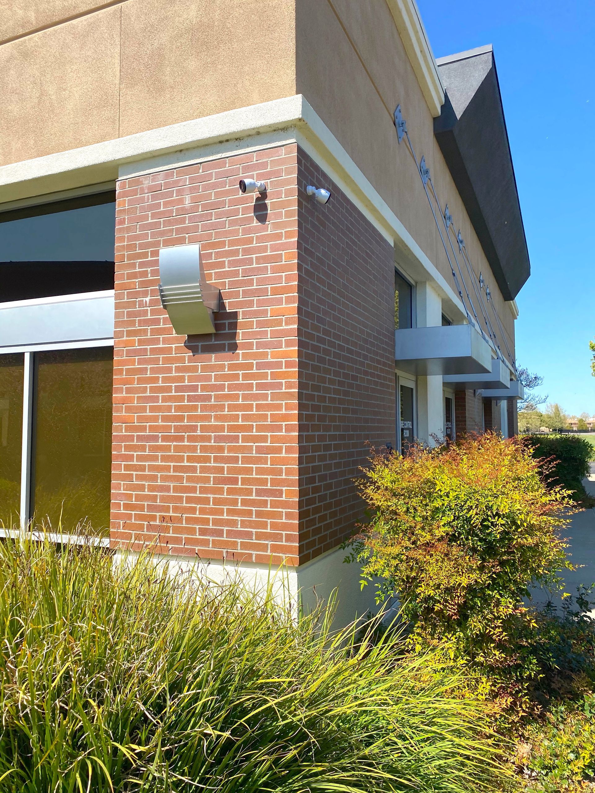 A brick building with a mirror on the side of it