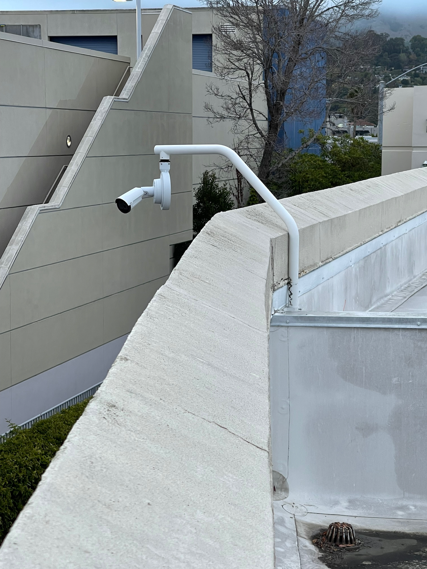 A security camera is mounted on the side of a building.