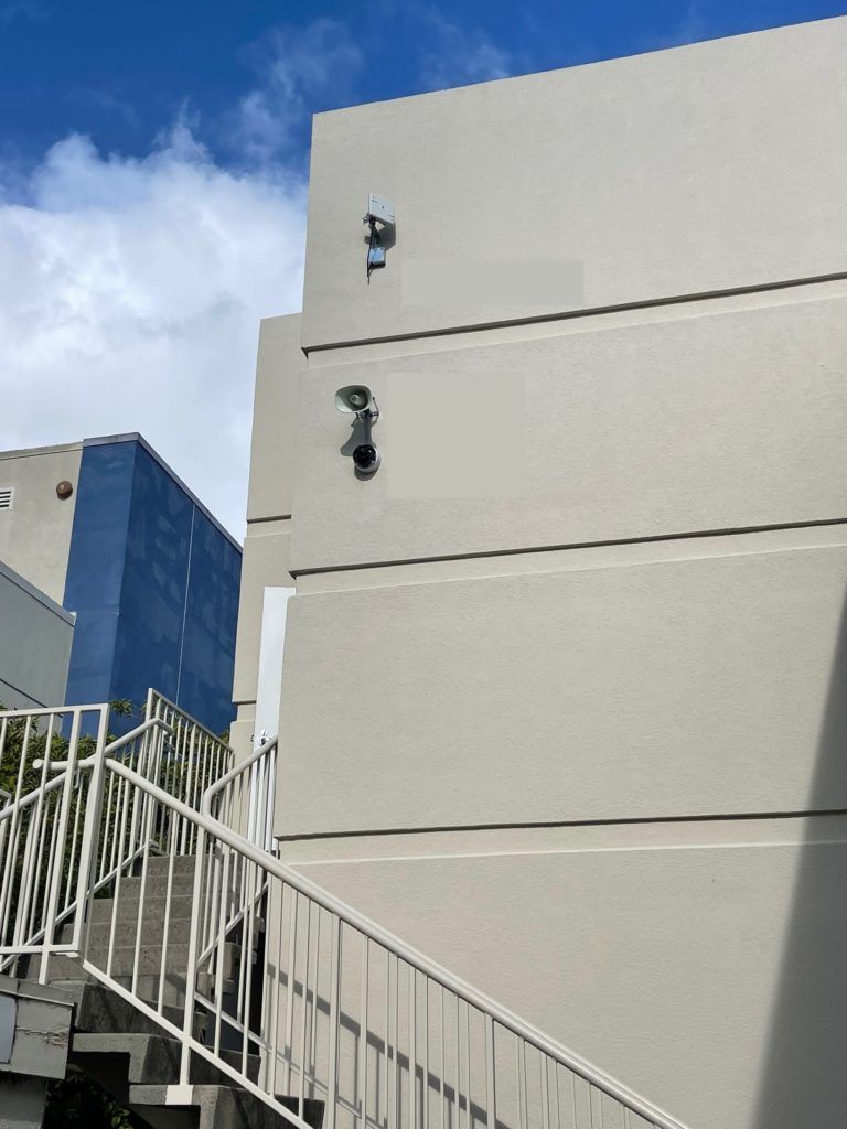 A white building with stairs leading up to it